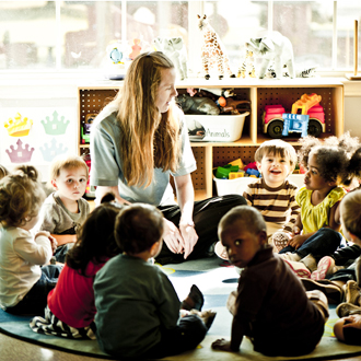 Children sitting in a circle around the teacher