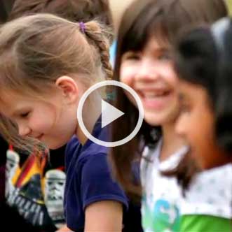 Childen smiling, video button