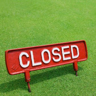 closed sign on a lawn