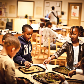 Children gathered around a table doing crafts