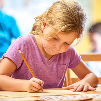 girl in classroom drawing