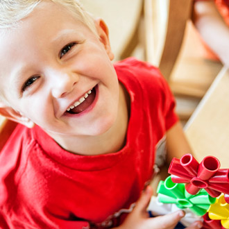 Smiling boy holding a toy