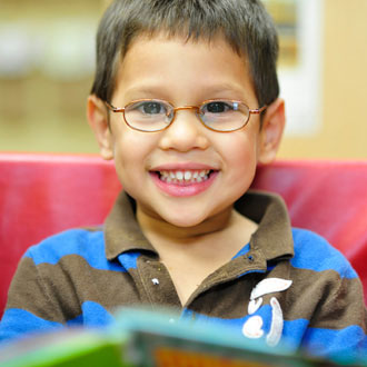 Boy with glasses smiling