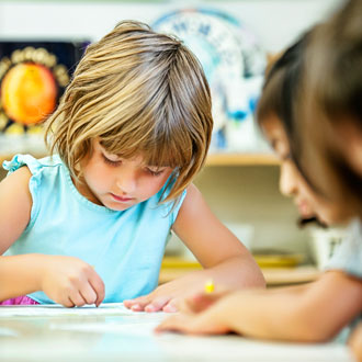 Kids at table writing