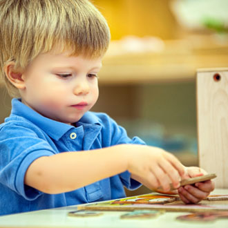 Boy playing with puzzle