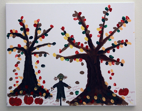 Child's painting of autumn trees, a scarecrow, and pumpkins