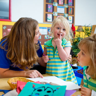 Children sitting in a circle around the teacher